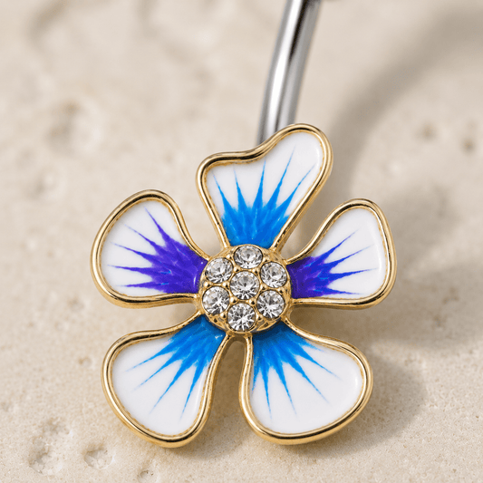 Close up of blue purple white enamel hibiscus flower with clear CZ gems, gold plated zinc alloy navel ring detail