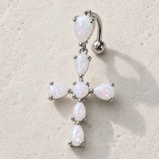 Close up of white synthetic opal cross prong set on navel ring, rainbow iridescent hues 316L stainless steel detail