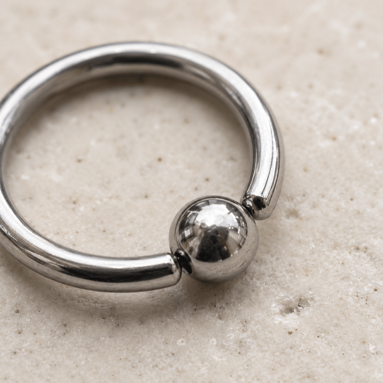 Close up of captive bead on 316L surgical steel annealed CBR ring, implant grade stainless steel detail
