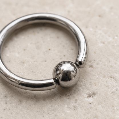 Close up of captive bead on 316L surgical steel annealed CBR ring, implant grade stainless steel detail