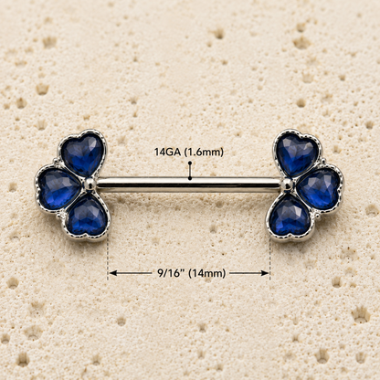nipple bars with blue gemstones on a beige background