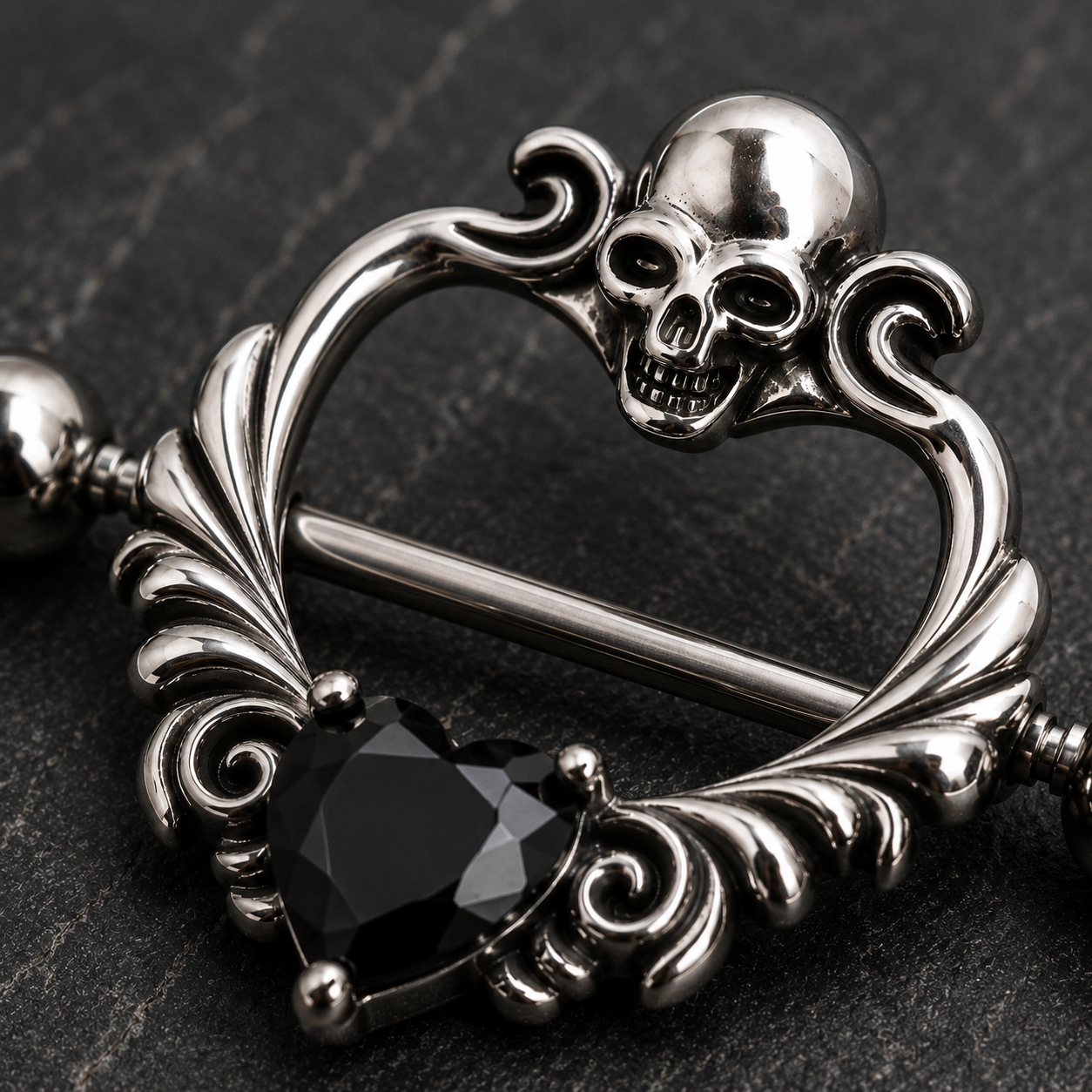 Close up of skull design top and black heart CZ on heart shaped nipple shield detail