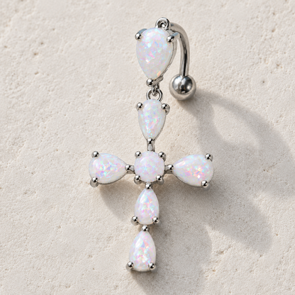 Close up of white synthetic opal cross prong set on navel ring, rainbow iridescent hues 316L stainless steel detail