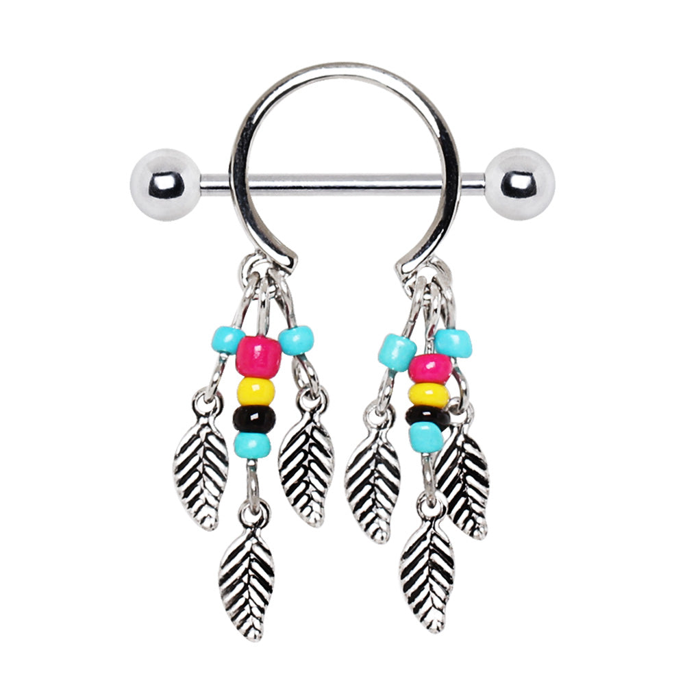 Styled flat lay of beaded feather dream catcher nipple shield pair, boho colorful body jewelry