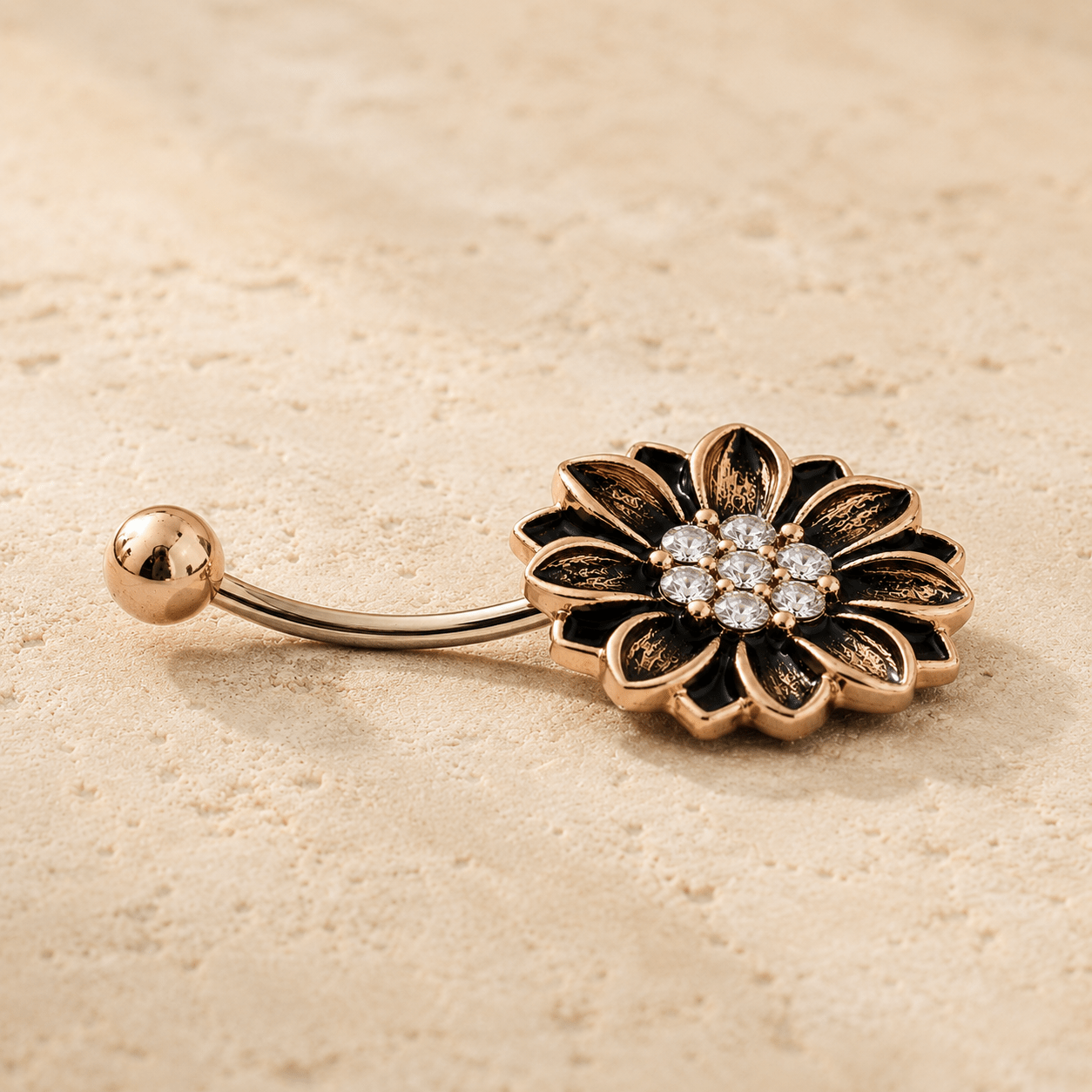 Side view of antique rose gold floral navel ring, 14G 316L stainless steel, sunflower design dark antique accents