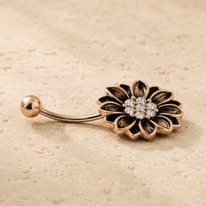 Side view of antique rose gold floral navel ring, 14G 316L stainless steel, sunflower design dark antique accents