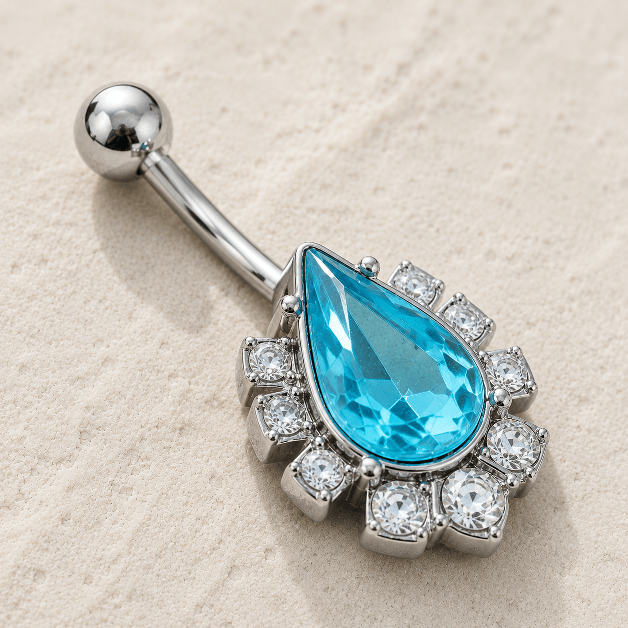 Side view of aqua teardrop CZ navel ring, 14G 316L stainless steel, 15 x 20mm total design belly ring