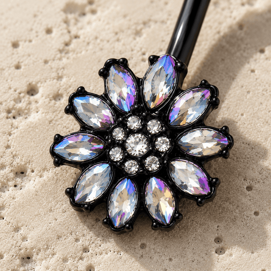 Belly button ring charm with rhinestone-like stones on a sandy background