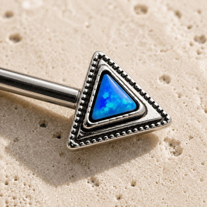 Close up of blue synthetic opal triangle and layered triangle design on nipple bar detail