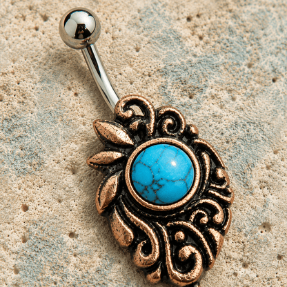 Close up of round turquoise stone and enchanting medieval detail on copper navel ring