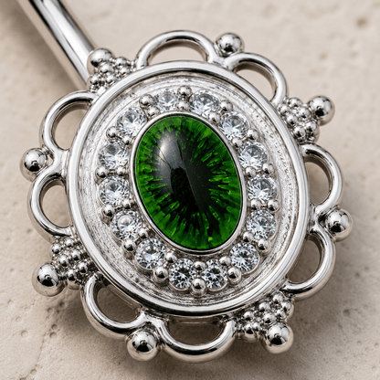 Close up of green eye design and cubic decoration on CZ mirror navel ring detail