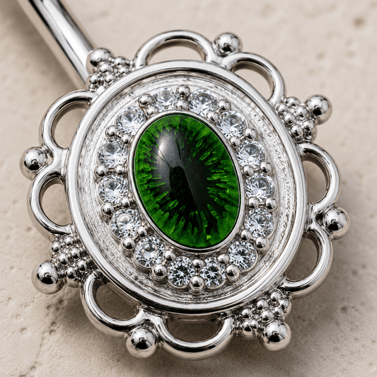 Close up of green eye design and cubic decoration on CZ mirror navel ring detail