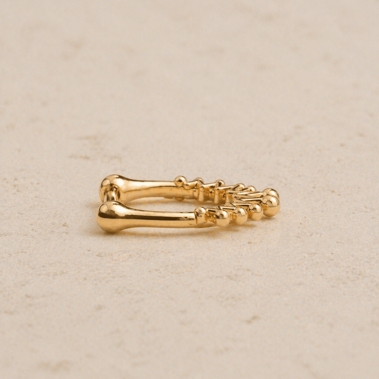 Side view of gold plated crown septum clicker, secure click closure, 16G stainless steel nose ring