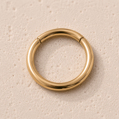 Close up of gold plated seamless clicker ring undetectable seam, yellow gold mirror polish surgical steel detail