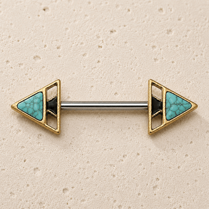 Pair of gold and turquoise nipple  bars on a beige background