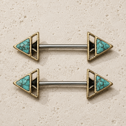 Pair of gold and turquoise triangle nipple barbell rings on a beige background