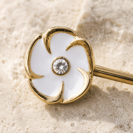 Close up of white enamel flower clear CZ center on gold plated nipple bar, yellow gold zinc alloy detail