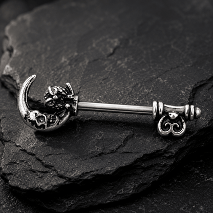Styled aesthetic flat lay of gothic owl moon skeleton key nipple bar pair, dark witchy alternative body jewelry