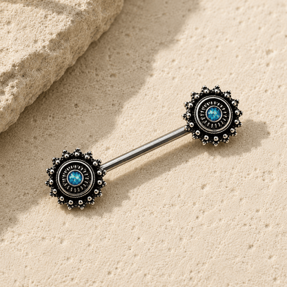 Styled flat lay of green opal ornate nipple bar pair, dark mystical black plated body jewelry
