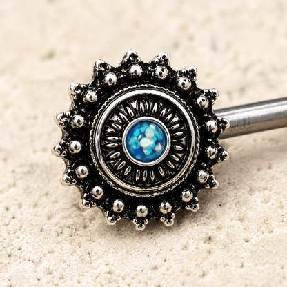 Close up of green synthetic opal center on ornate nipple bar, black plated zinc alloy detail
