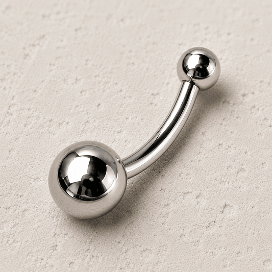 Close up of solid titanium balls on implant grade navel ring, Ti6AL4V ELI smaller top bigger bottom detail