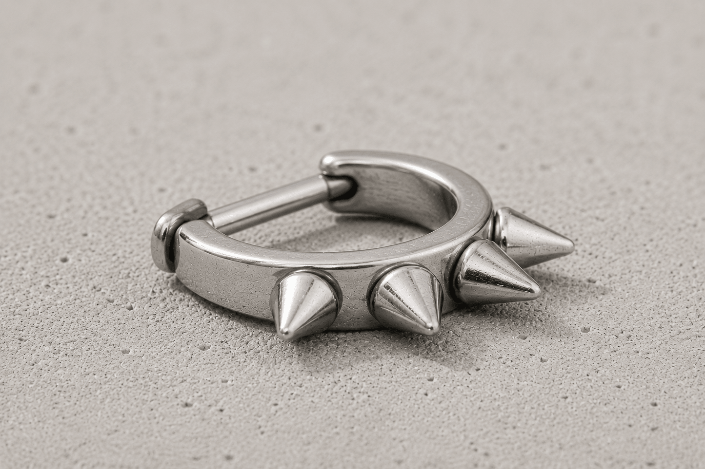 cartilage cuff with spike detailing on a concrete surface