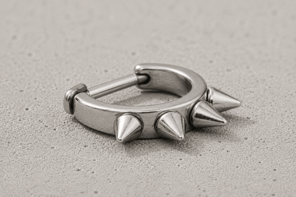 cartilage cuff with spike detailing on a concrete surface