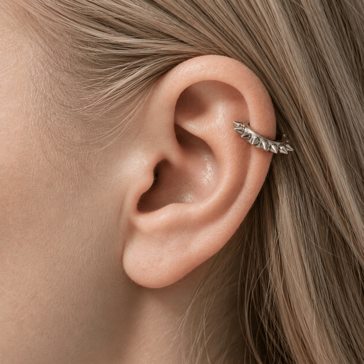 Close-up of an ear  cuff with a silver earring
