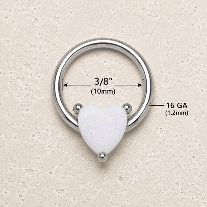 Heart-shaped white opal ring with measurements on a beige background