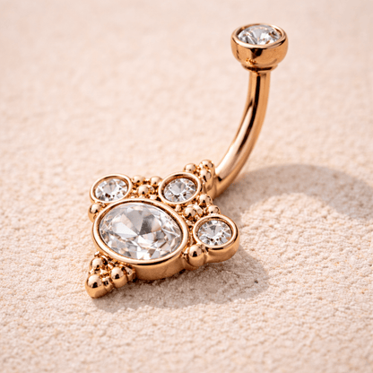 Side view of rose gold plated Victorian belly button ring, 14G curved barbell, clear CZ top ball