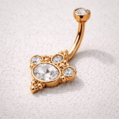 Side view of rose gold plated Victorian belly button ring, 14G curved barbell, clear CZ top ball