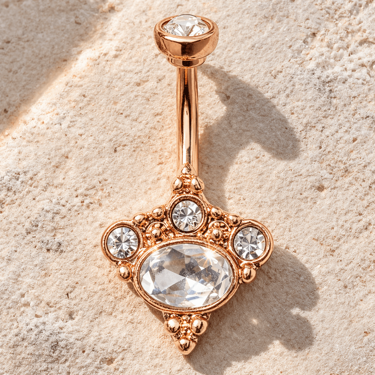 Rose gold Victorian navel ring styled flat lay, romantic vintage inspired belly button ring, clear CZ gems
