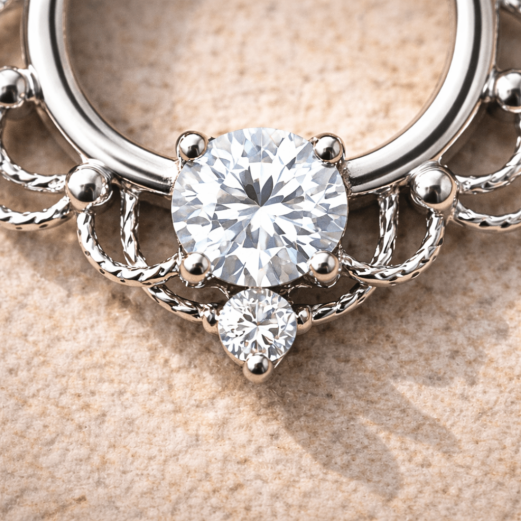 Silver ring with two round diamonds on a beige background