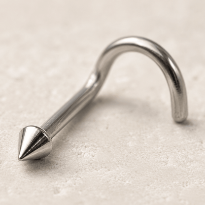 Close up of ball dome spike tops on stainless steel screw nose ring, mirror polished implant grade detail