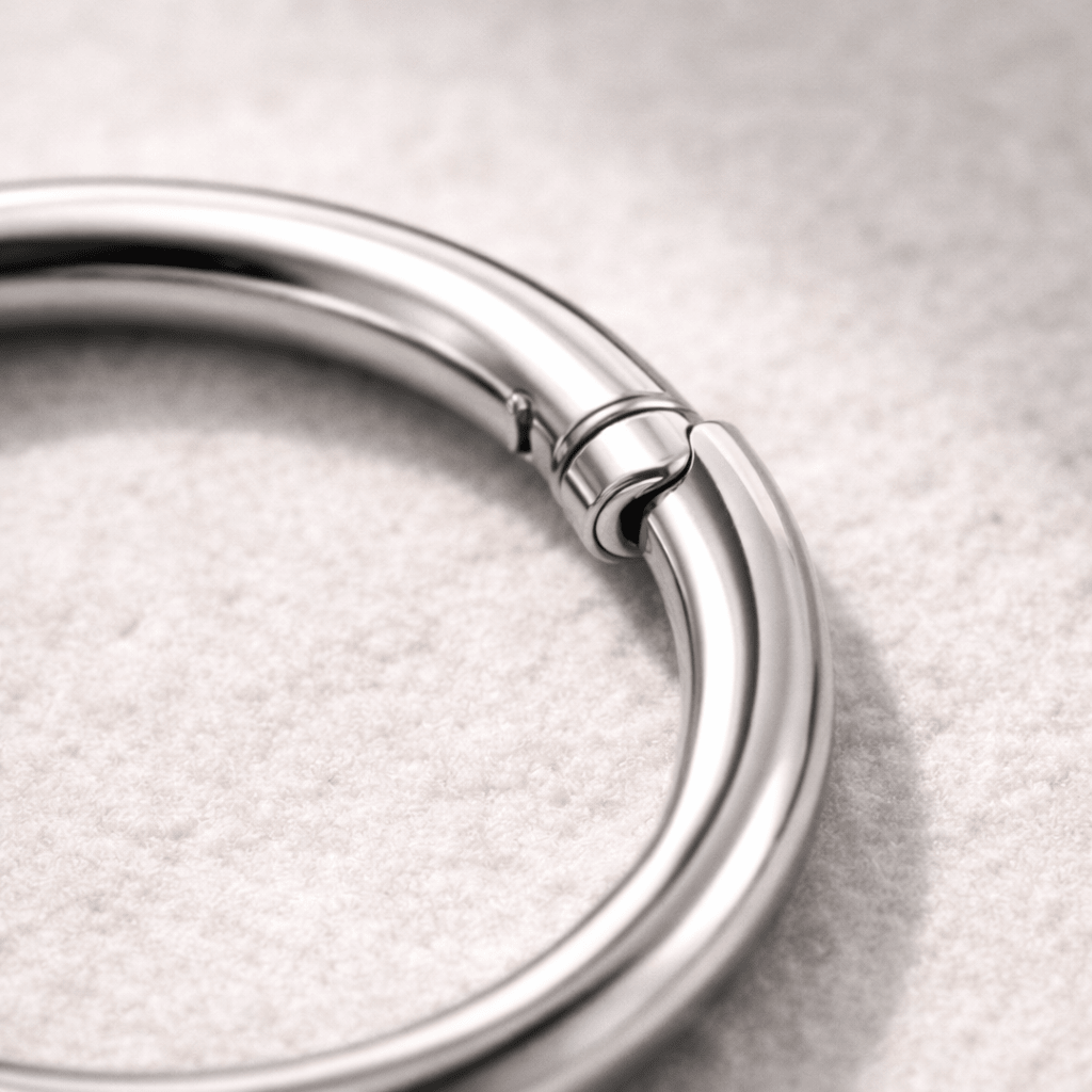Close up of titanium seamless clicker ring click closure, implant grade Ti6AL4V ELI smooth finish detail