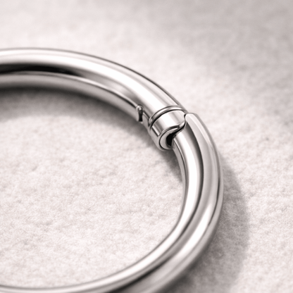 Close up of titanium seamless clicker ring click closure, implant grade Ti6AL4V ELI smooth finish detail