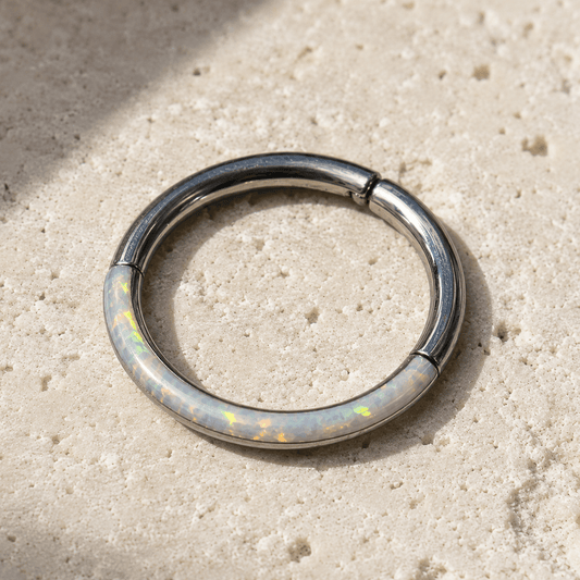  Opal Seamless Clicker Ring opal inlay on a beige stone surface